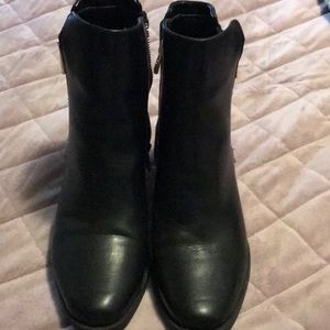 Black ankle boots with suede on heel.
